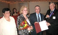 Grand Knight Mike Carroll and his wife Bannet present William and Nancy Grodesky flowers and a Certificate recognizing their 40th wedding anniversary.